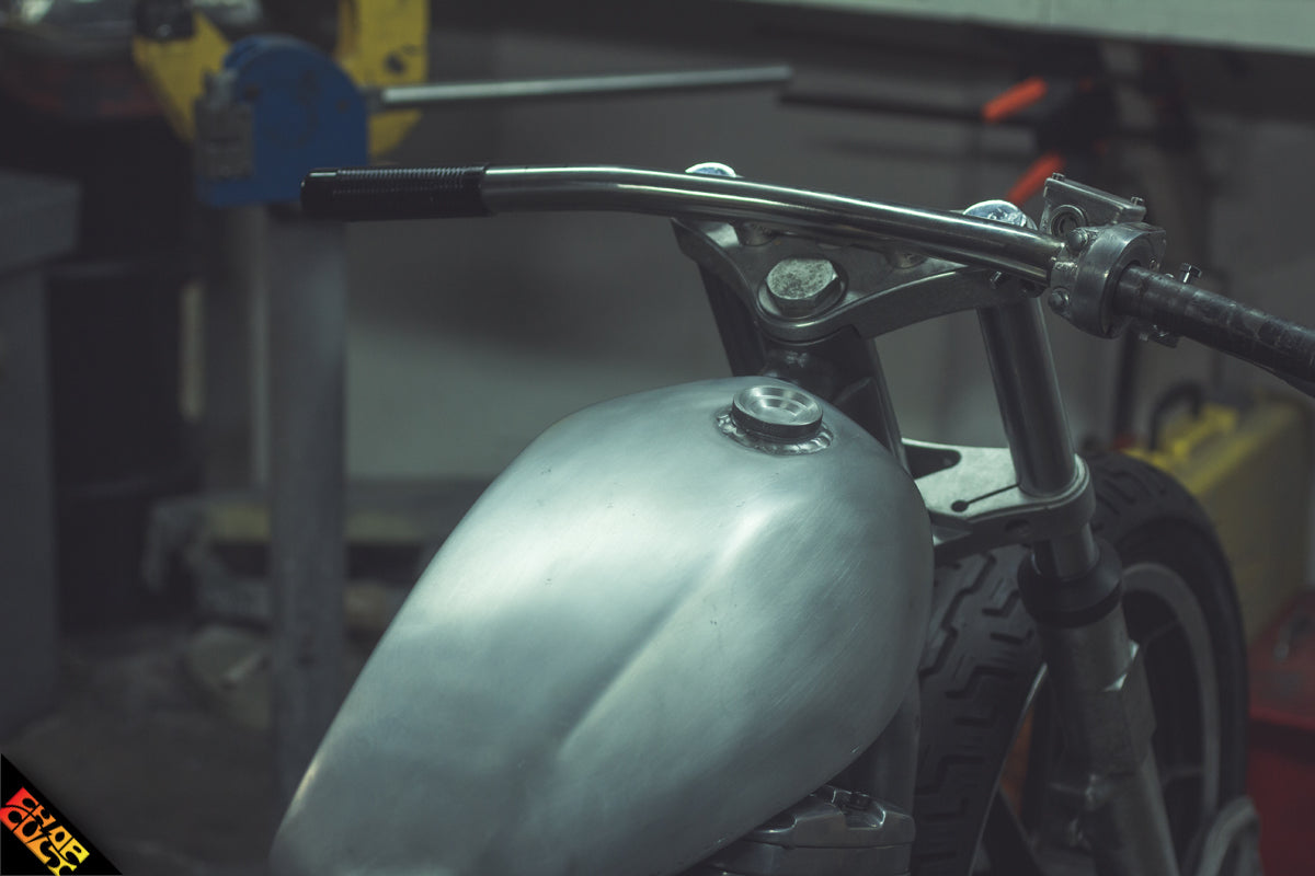 Custom sportster motorcycle handlebars in shop