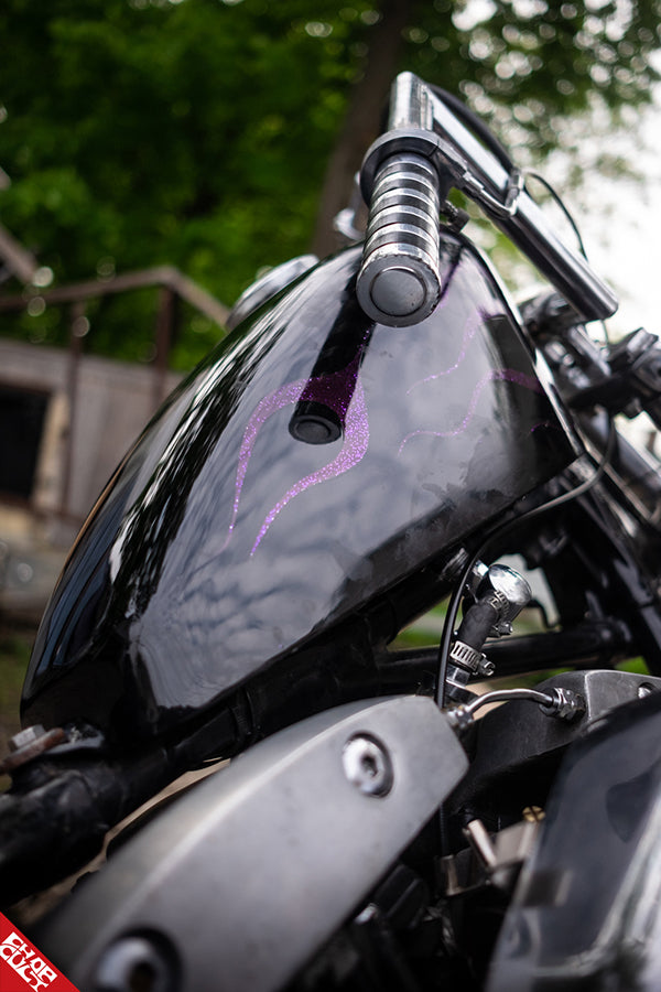 A close up of the glittering purple flames painted on the black bike