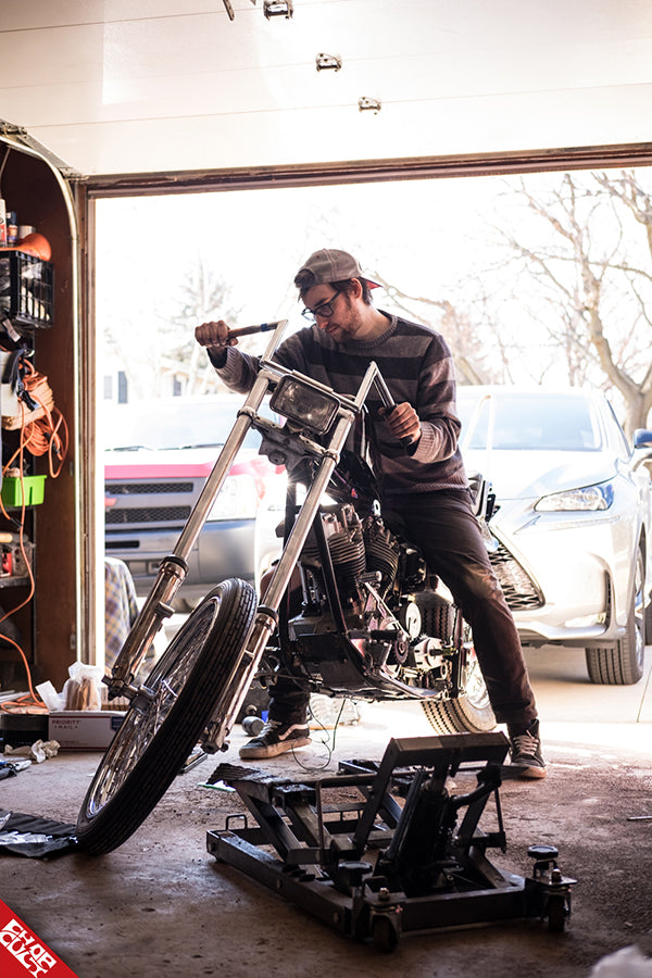 Andrew in the garage with his bike