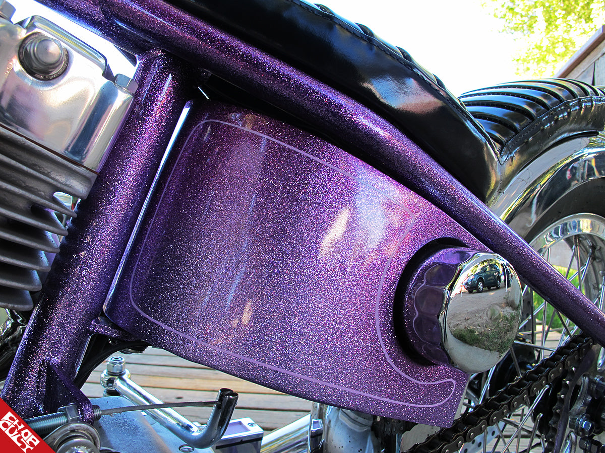 A close up of the purple glittery paint below the bike's seat