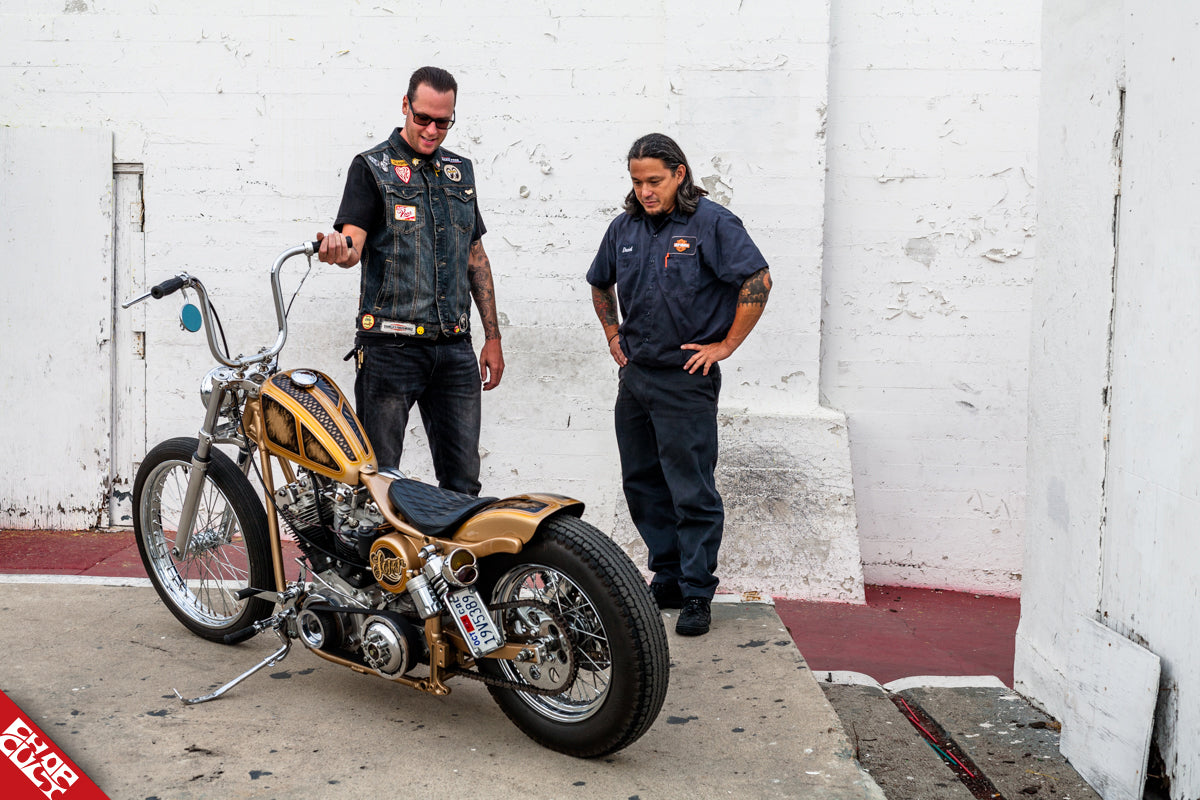 An image of Chris showing his bike to a friend