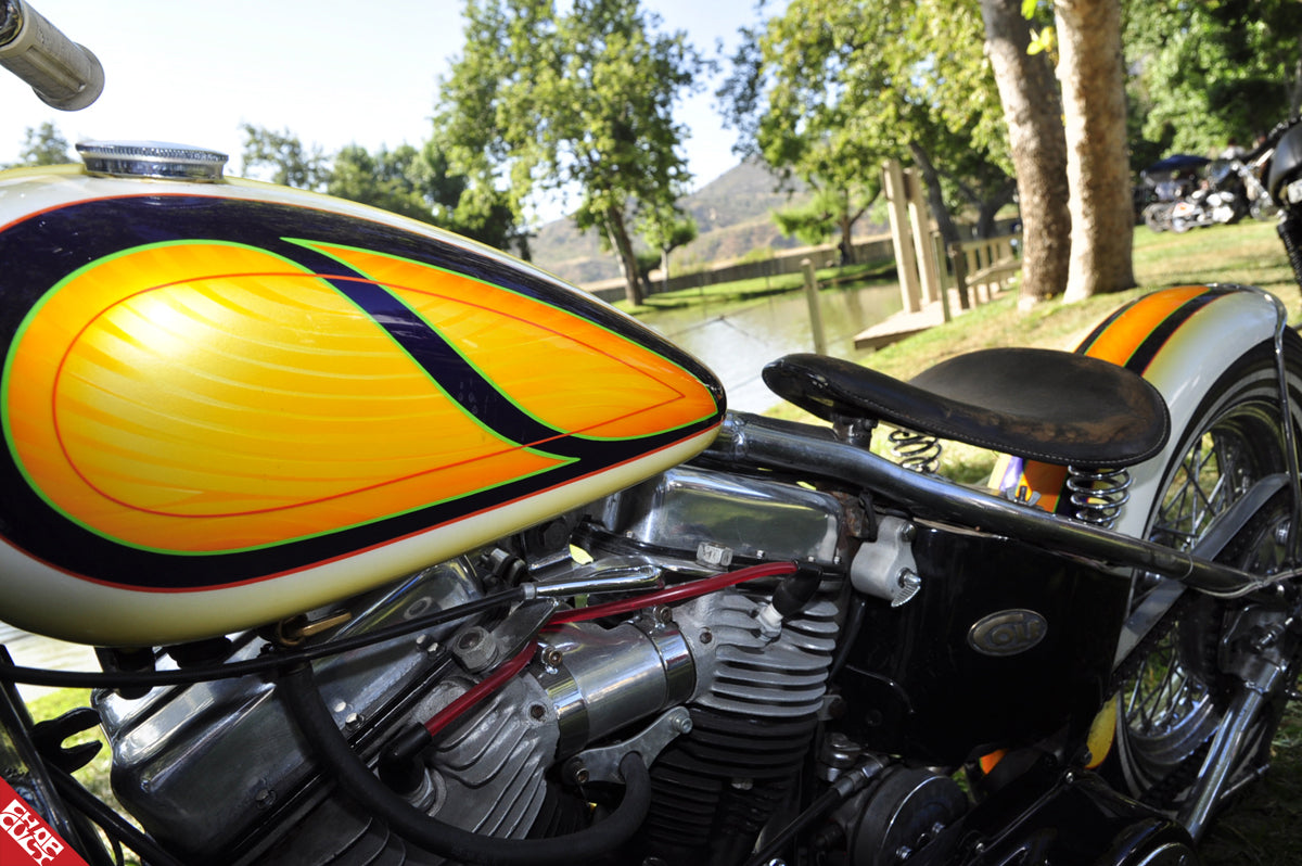 A close up of the bike's clean cream, orange, yellow, and black design
