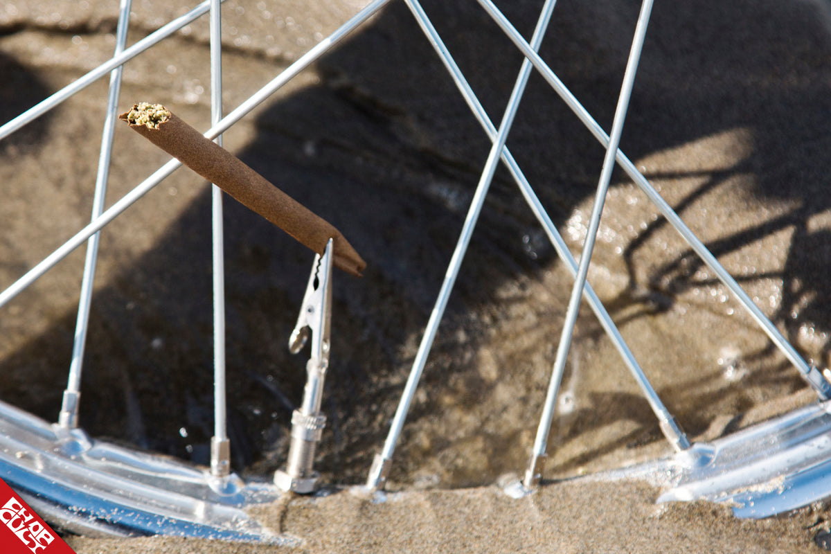 A close up of the front tire spokes on the bike