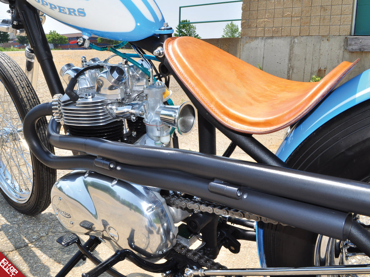 A close up of the bike's seat and motor pipes