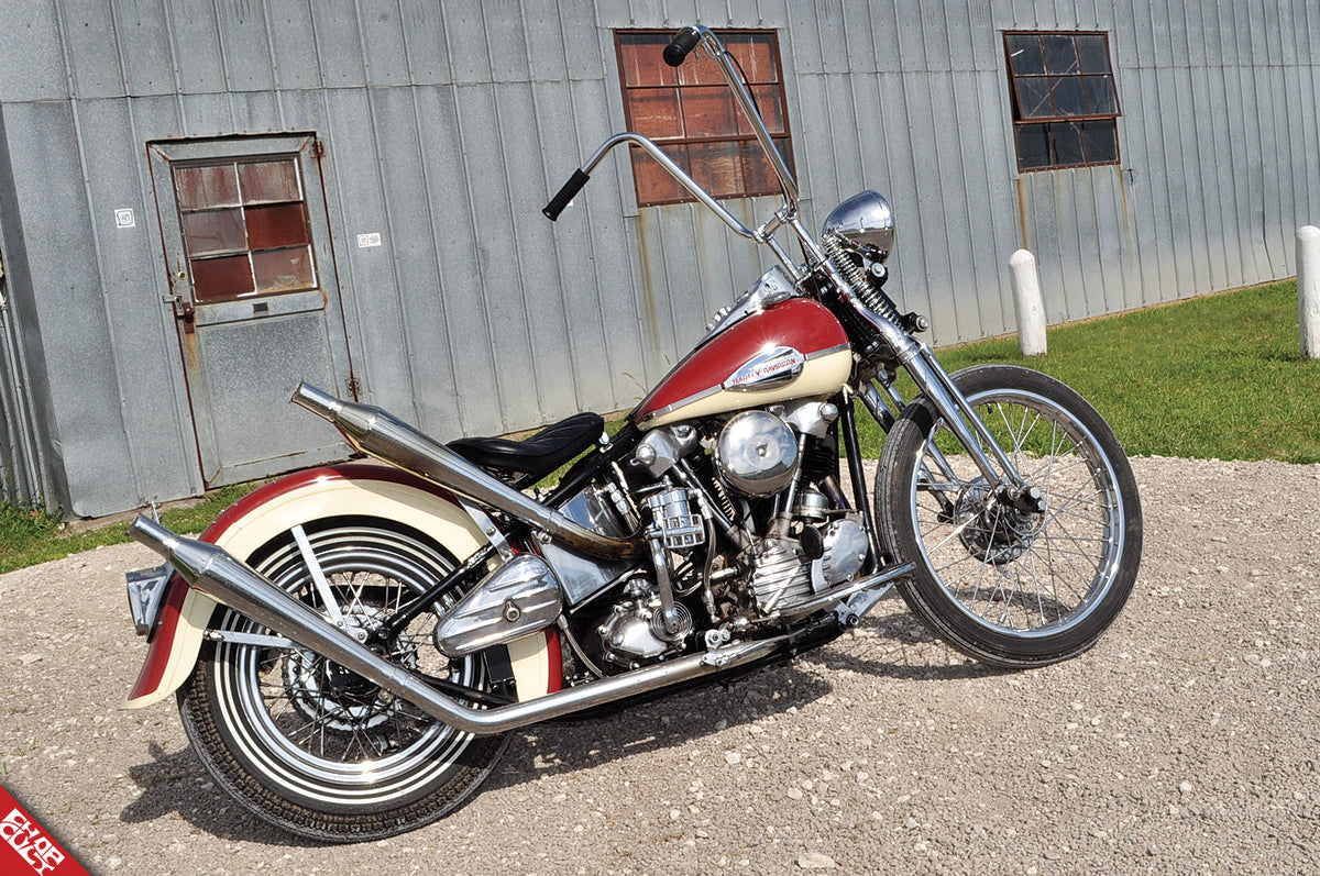 A side view of the red and cream colored bike